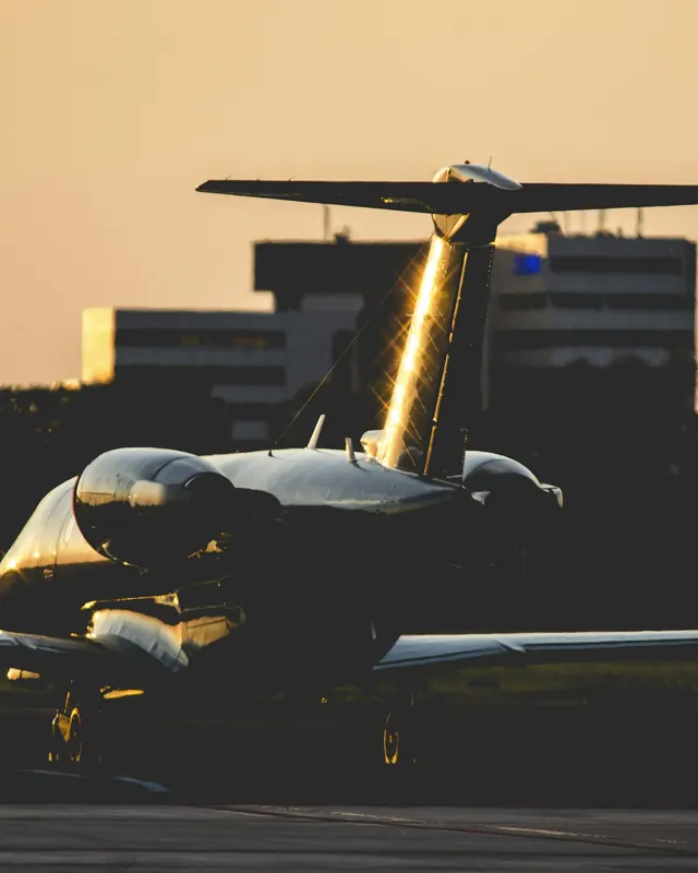 Business jet on the ramp at night with its tail lit