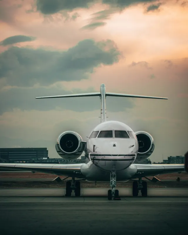 Business jet facing the camera on the ramp at dusk