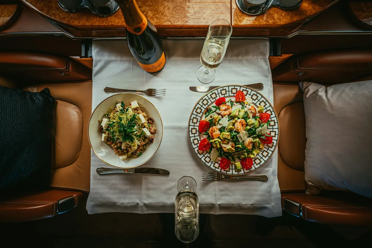 Lunch served on a white tablecloth between leather club seats