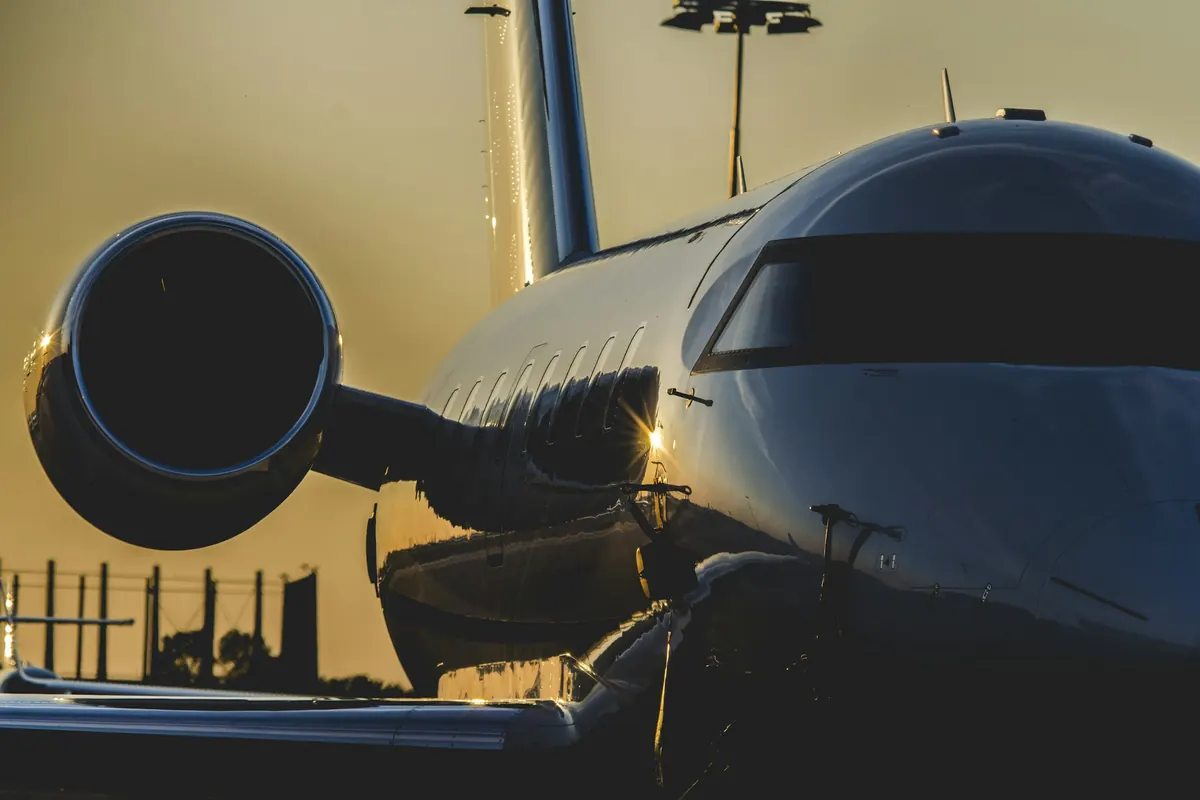 Engine and fuselage of a business jet in warm evening light