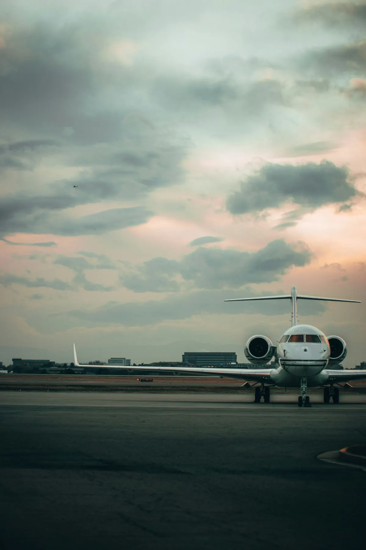 Business jet on the ramp beneath a wide evening sky