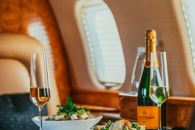 Champagne and a light lunch served beside a cabin window
